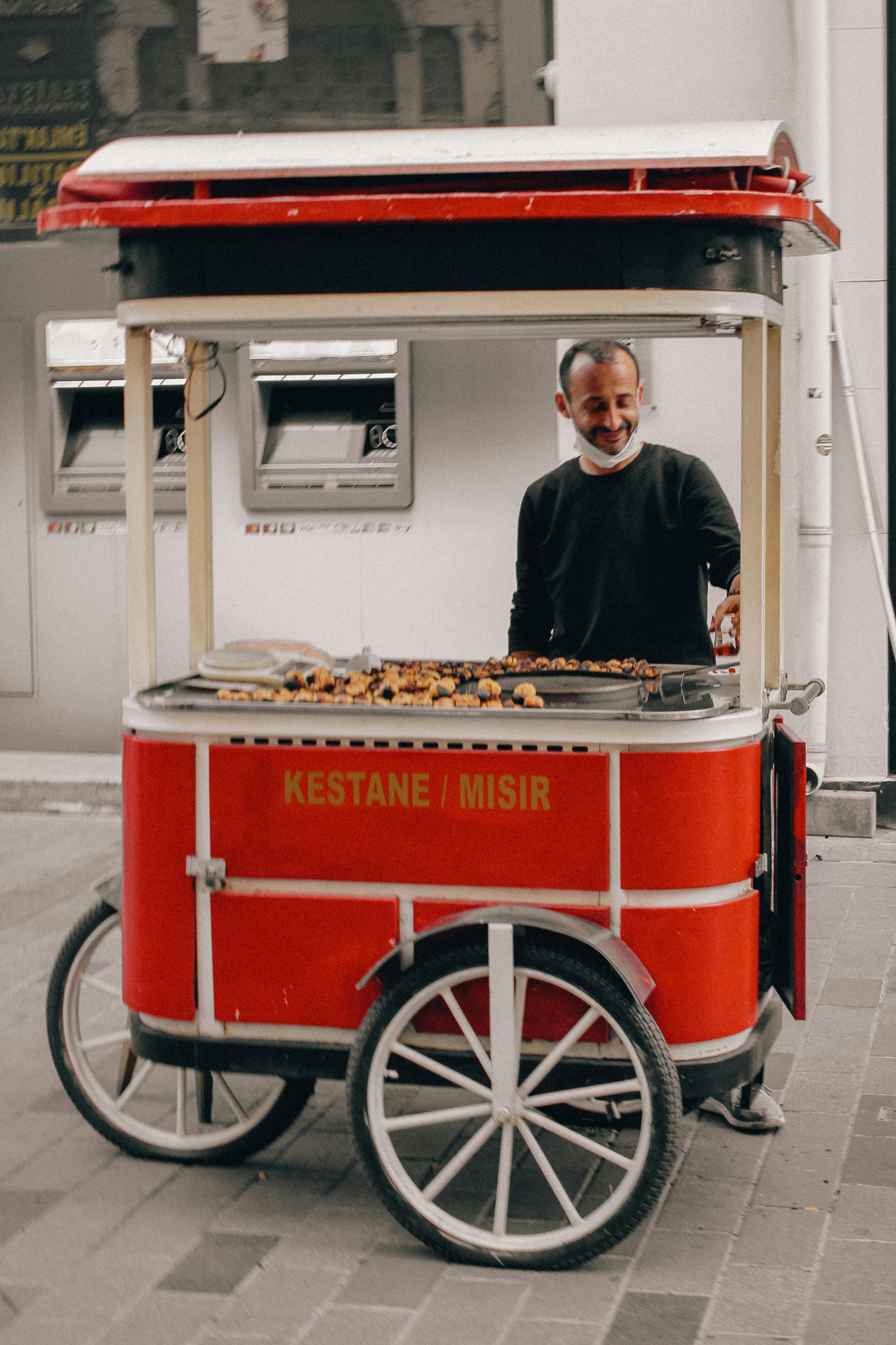 man selling baking chestnuts