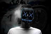 Grayscale Photo of Man Wearing Blue Mask