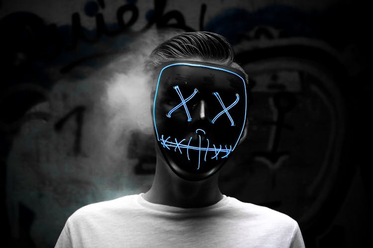 Grayscale Photo Of Man Wearing Blue Mask