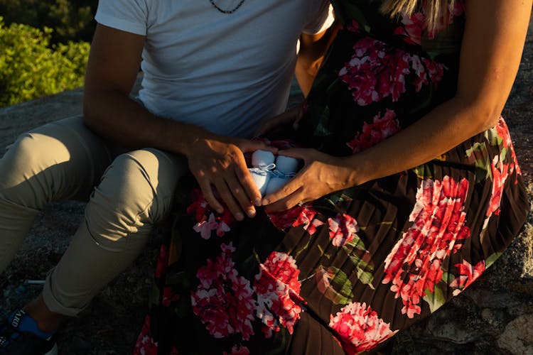 Couple Holding Baby Shoes