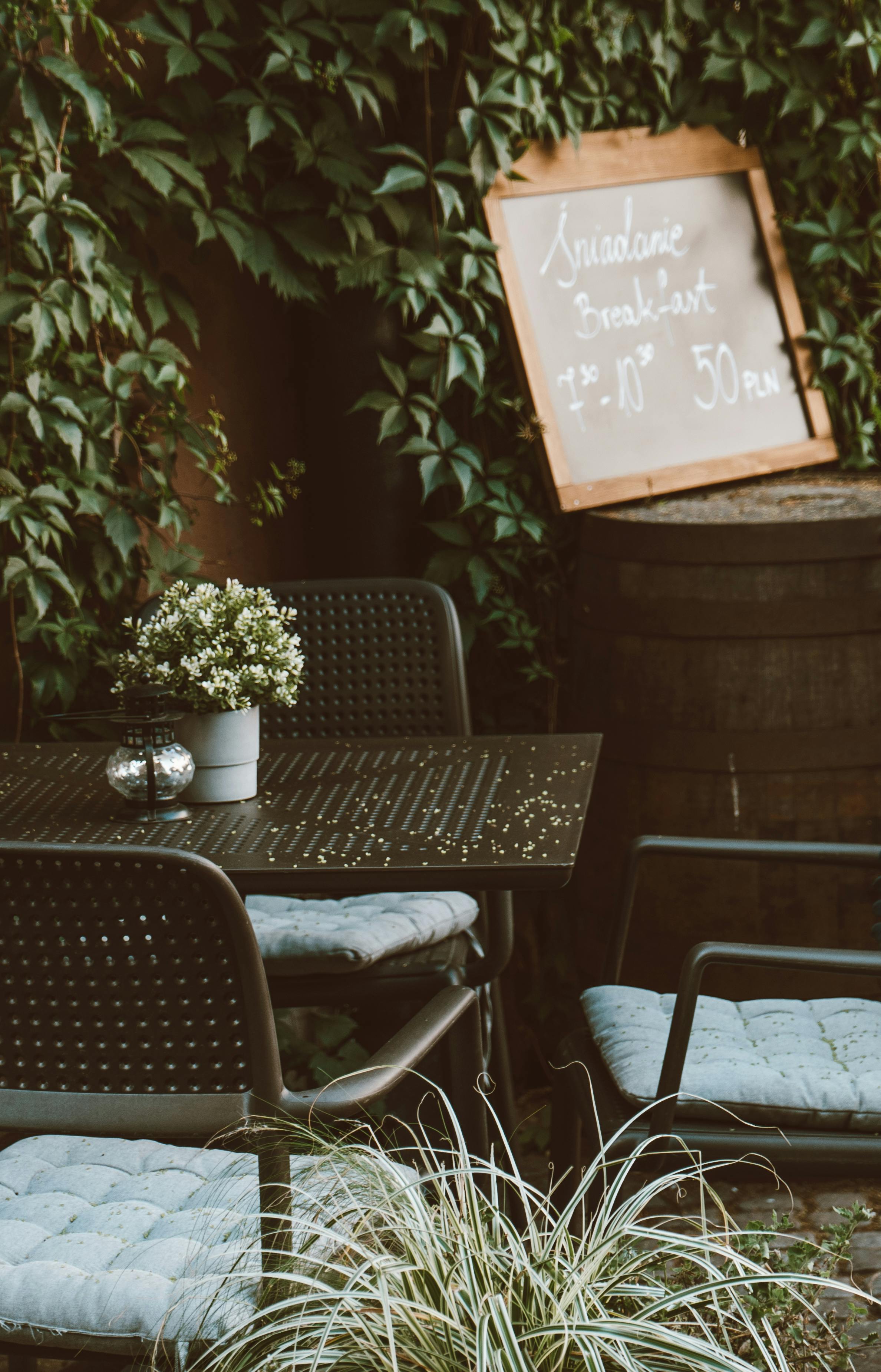 Black Metal Table and Chairs in an Outdoor Coffee Shop · Free Stock Photo