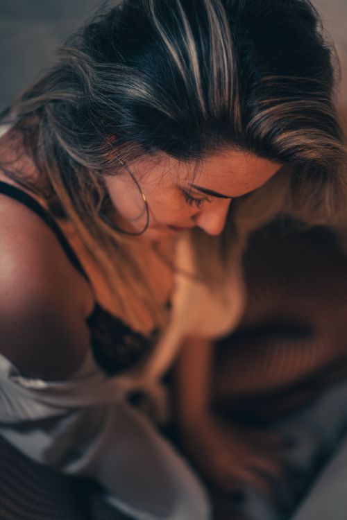 Free Close-up of a woman in an off-shoulder top and black bra, embracing fashion. Stock Photo