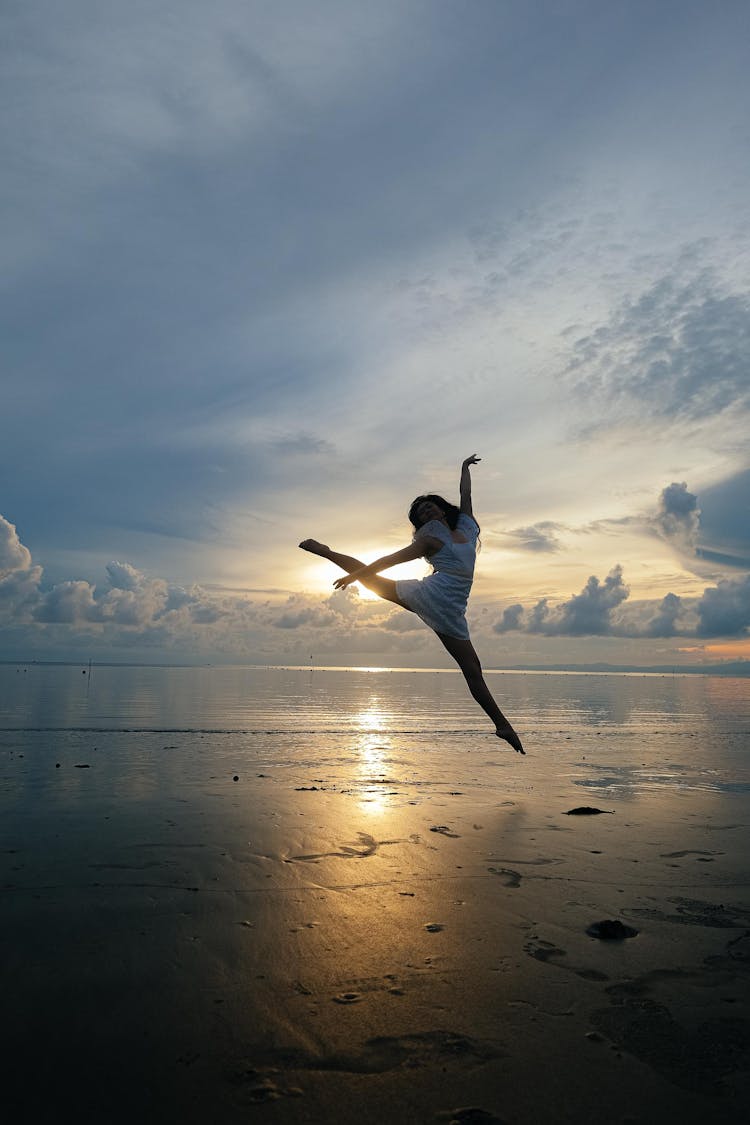 A Jump Shot Of A Woman At The Beach