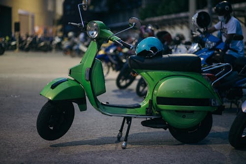 Free Green Motor Scooter Parked on Road Stock Photo