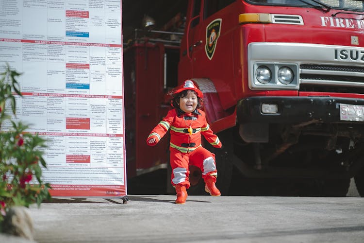 A Boy In Fireman Costume