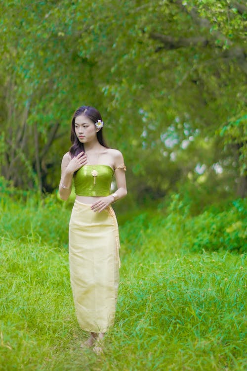 Woman in Green Tube Top Standing on Green Grass Field