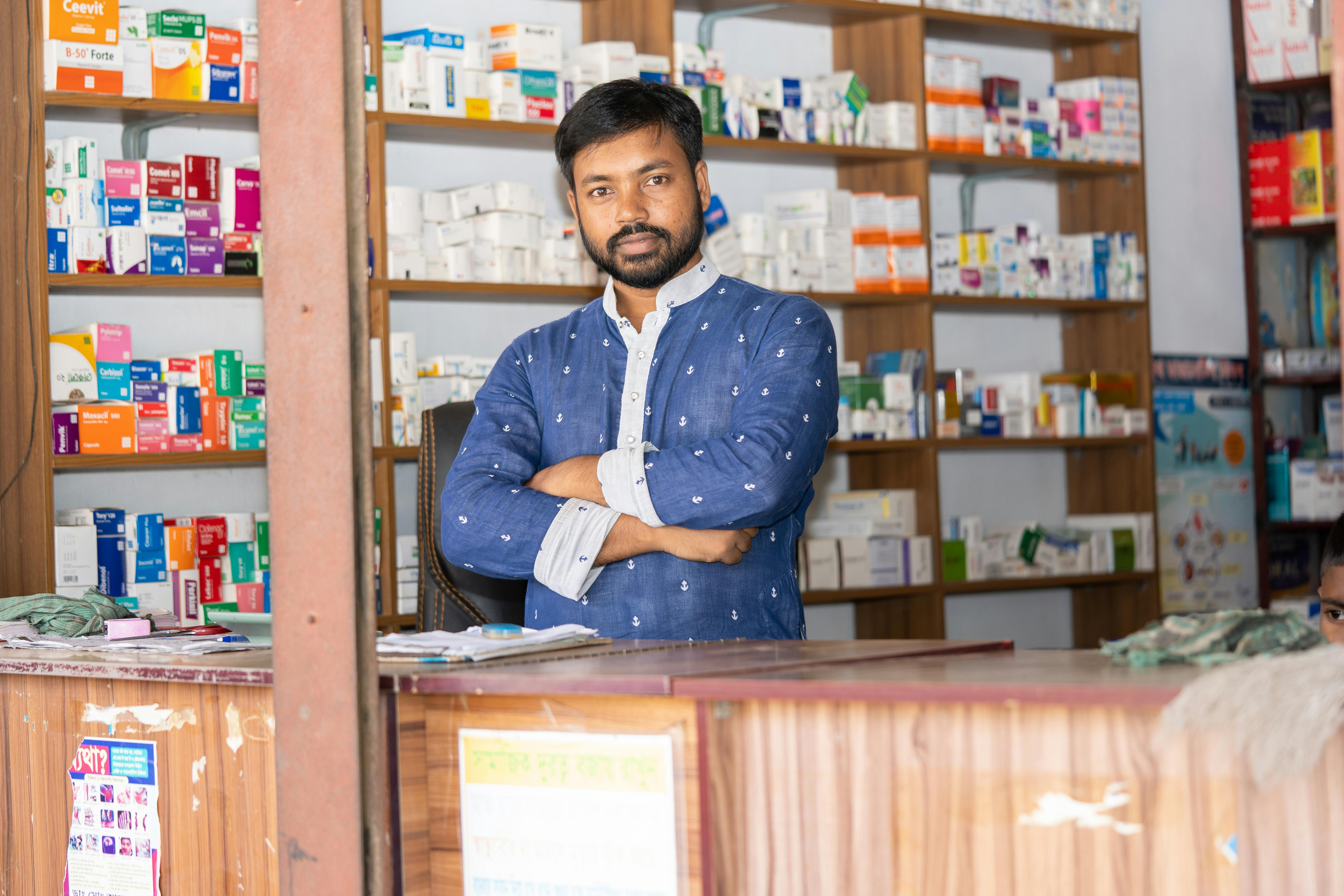 professional pharmacist in modern drugstore space for text