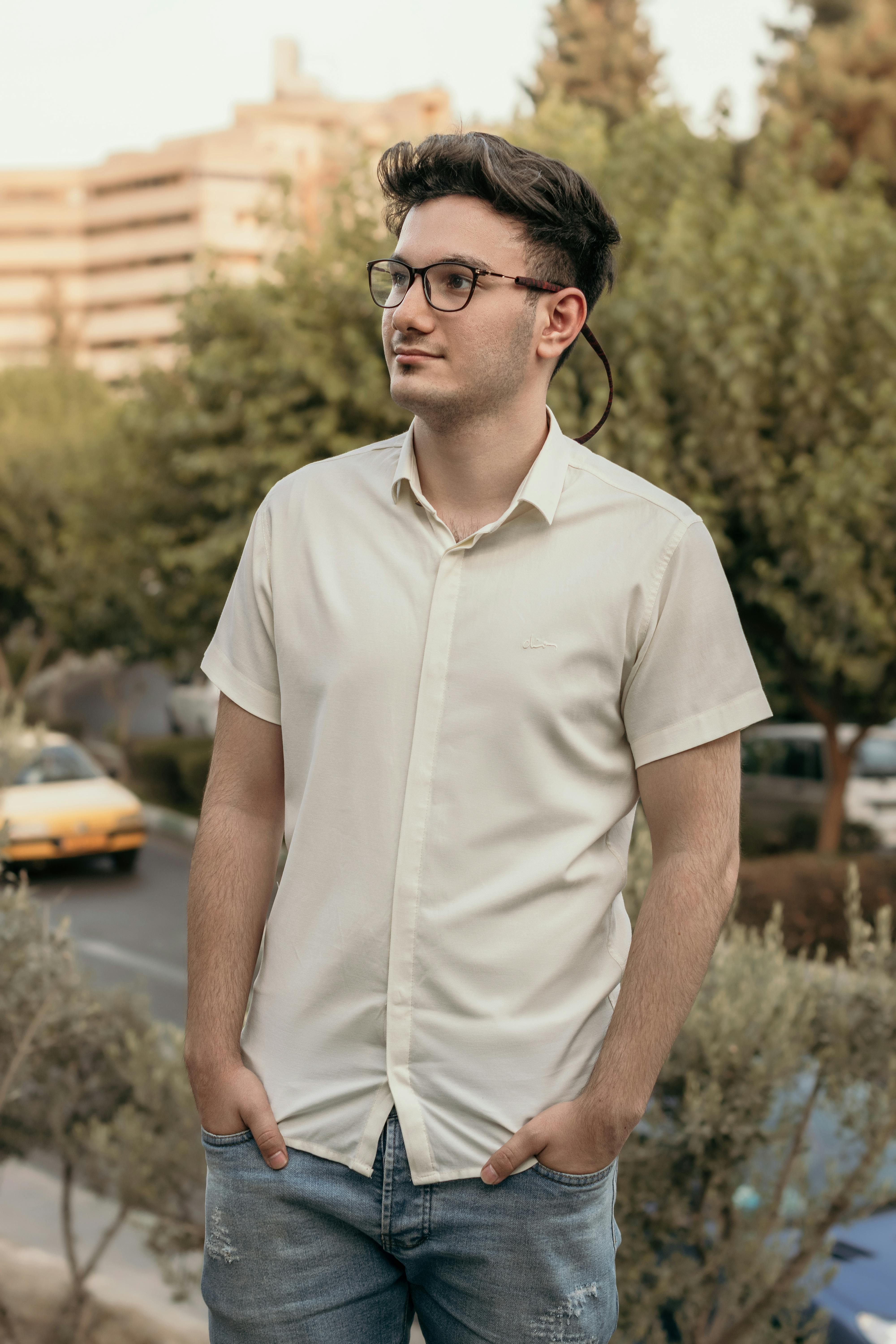 Man in White Button Up Polo and Denim Pants Free Stock Photo