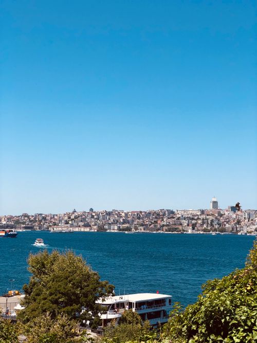 Free Scenic view of a city skyline across a blue harbor on a clear day. Stock Photo