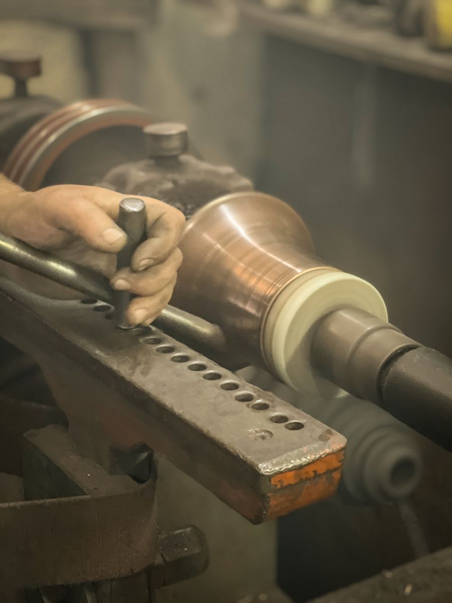 Metal component being turned on an industrial lathe