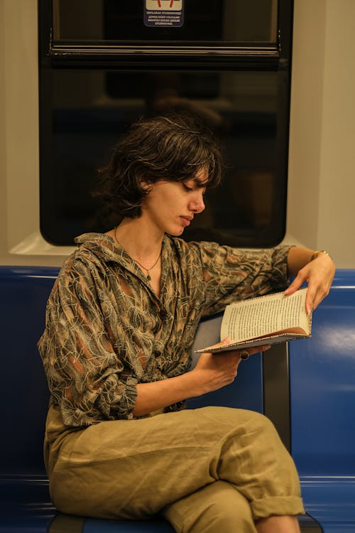 Woman in a Train Ride Reading a Book
