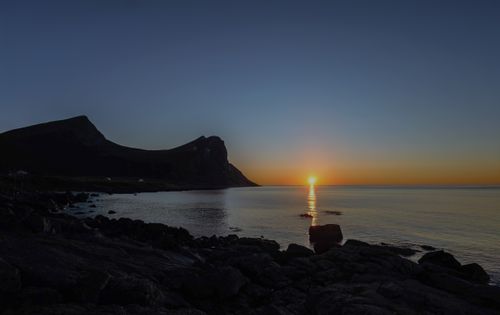 Free Captivating sunset over Myrland's rocky seascape with serene ocean views in Viken, Norway. Stock Photo