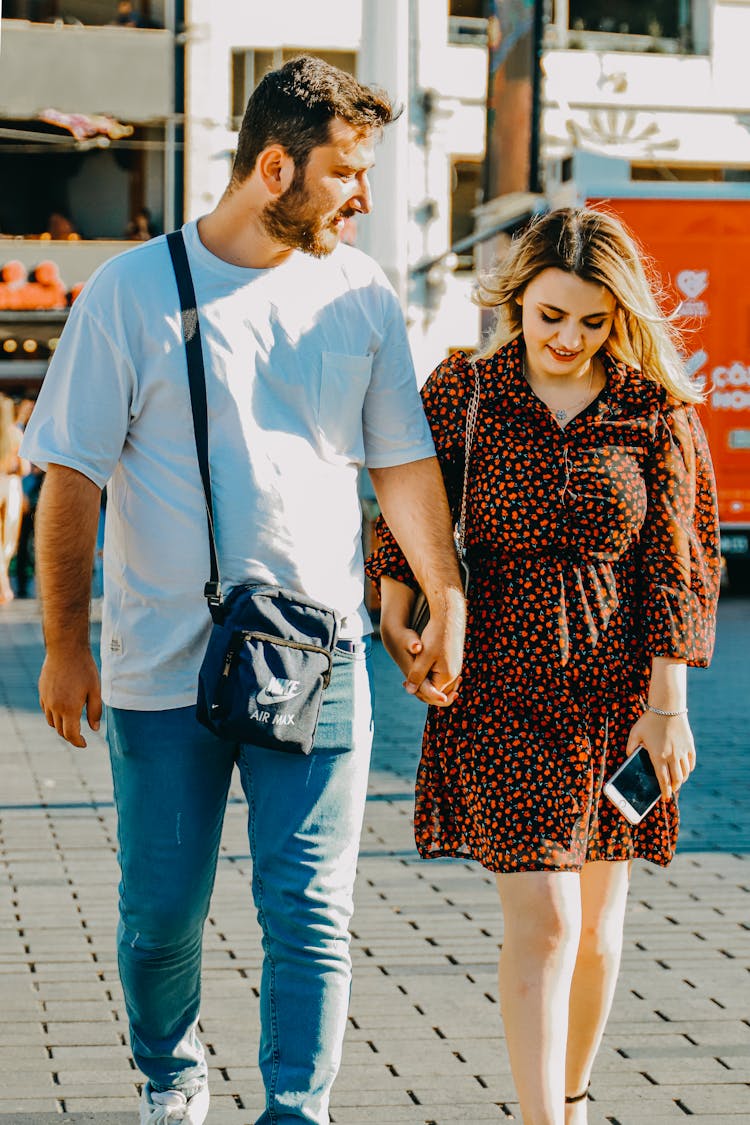 Couple Holding Hands While Walking