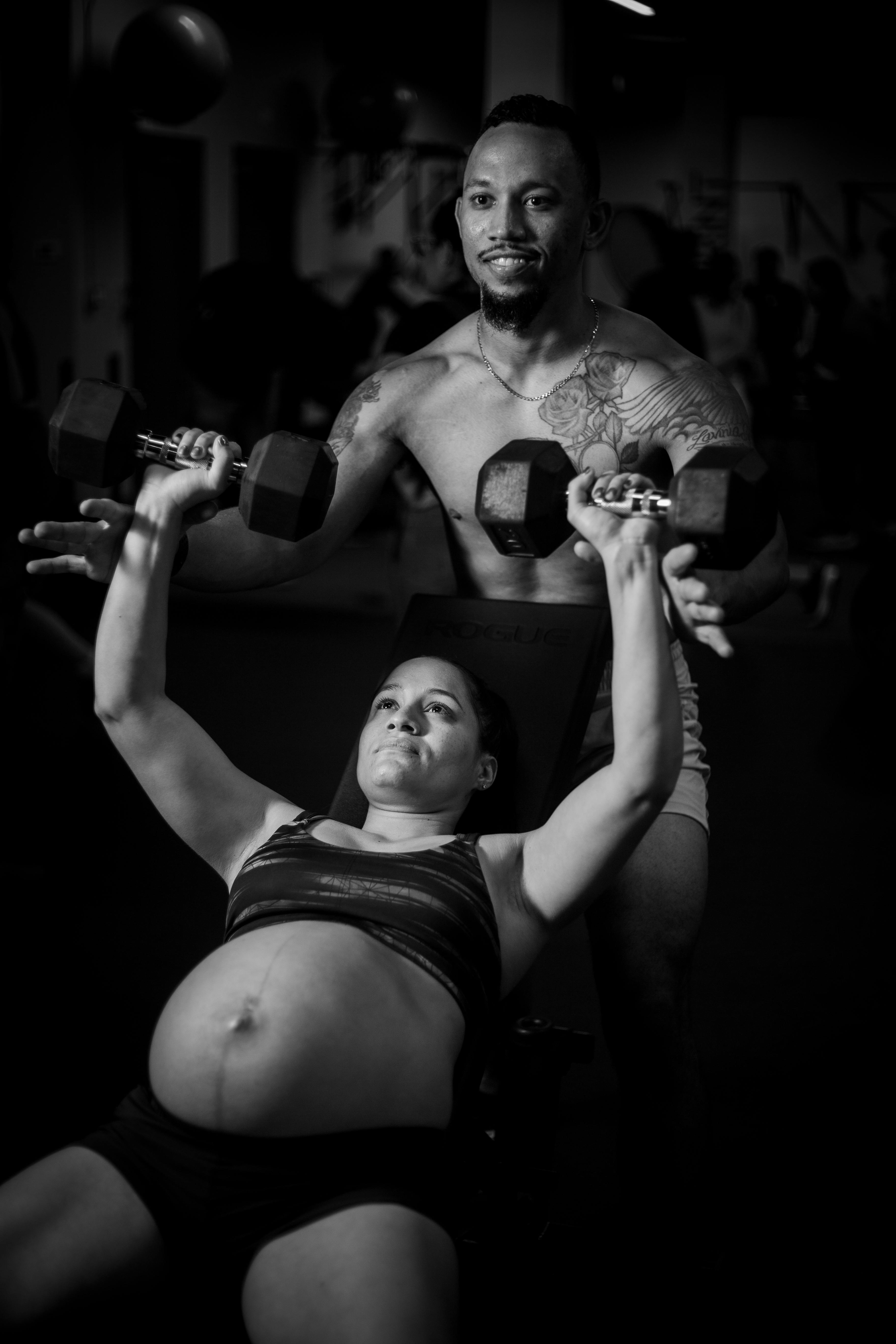 A Woman in Black Tank Top and Shorts Holding A Dumbbell · Free Stock Photo
