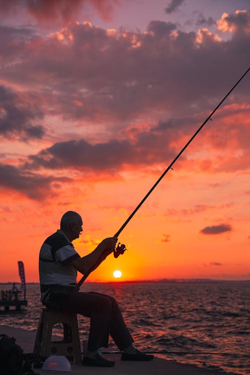 Photos gratuites de aube, canne à pêche, coucher de soleil