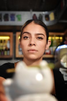 Close-up of a woman in a café, capturing focused expression and engaging atmosphere.
