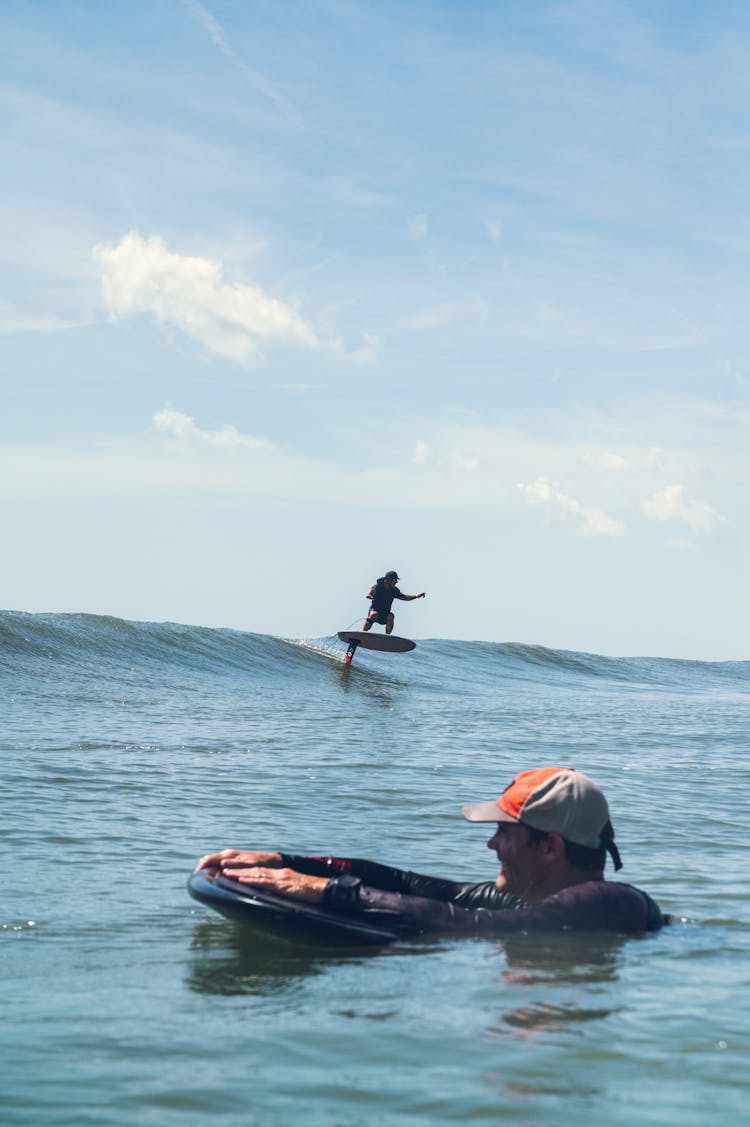 Men Surfing The Sea Waves