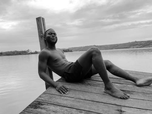 Shirtless Man on Wooden Dock