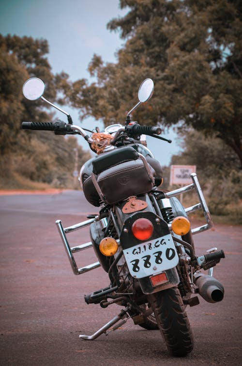 Back View Shot of Black Big Bike Near Green Trees