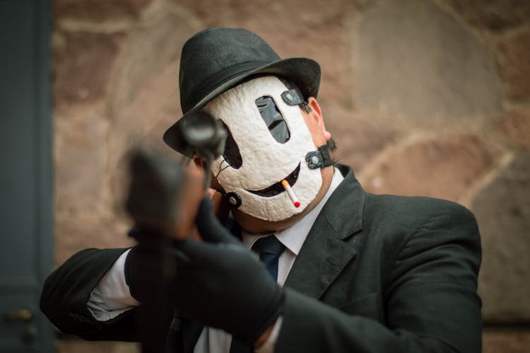 Man In Black Suit Jacket Wearing White Mask