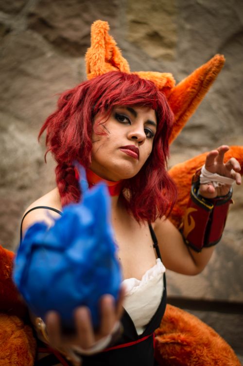 Free A captivating cosplay character with red hair and fiery costume, posing with dynamic energy. Stock Photo