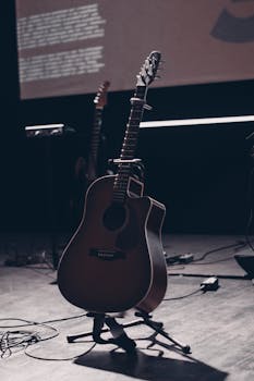 Captivating acoustic guitar in spotlight, ready for a performance on stage.
