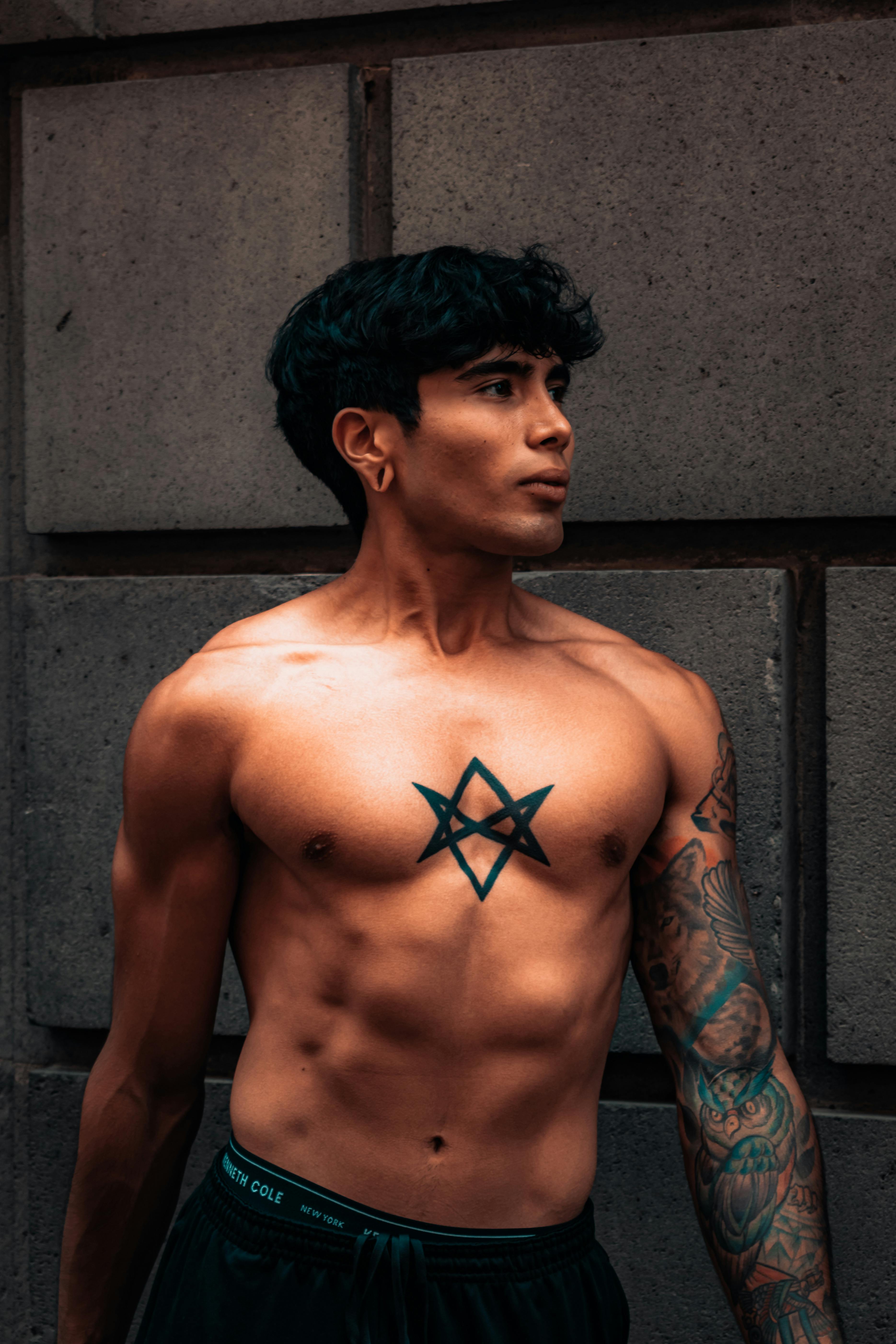 Cross With Wings Tattoo On Man Chest