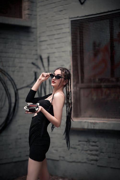 Woman in Black Dress Wearing Sunglasses