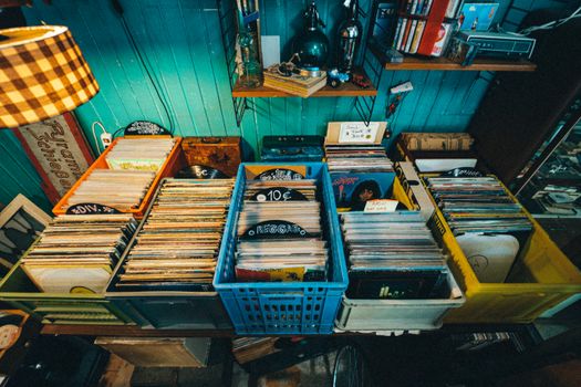 Explore a vibrant collection of vintage vinyl records in a retro store setting. Perfect for music enthusiasts.