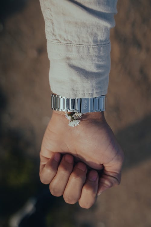 A Person Wearing Silver Wristwatch