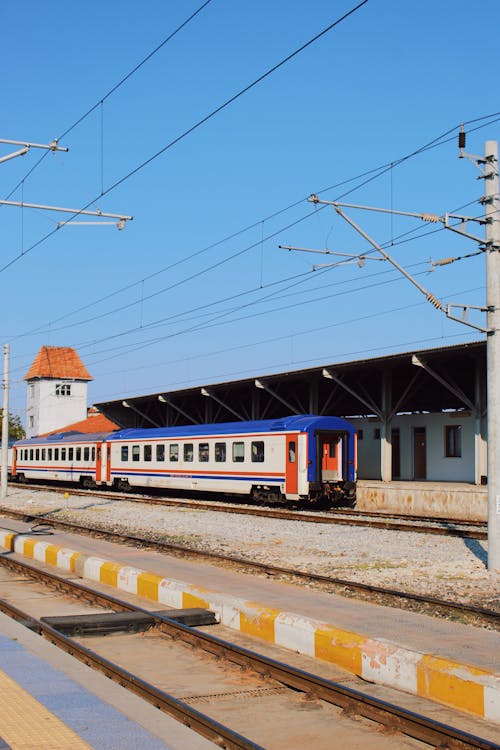 White and Blue Train on Rail Tracks