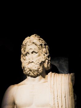 A striking portrait of a classic Greek marble sculpture of Zeus, showcasing intricate details under dramatic lighting.