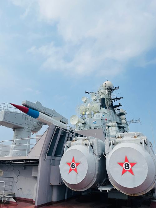 Free A detailed view of a naval battleship featuring missile launchers under a clear sky in Tianjin, China. Stock Photo