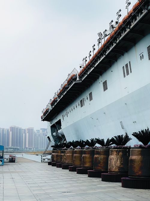 Free A large vessel docked in Bin Hai, Tianjin, with city skyline in the background. Stock Photo