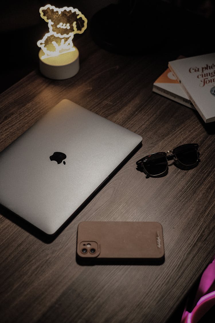 Laptop, Phone And Sunglasses On A Desk