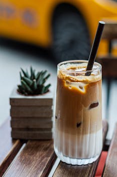 Iced latte with milk on a wooden café table in Istanbul, Turkey.