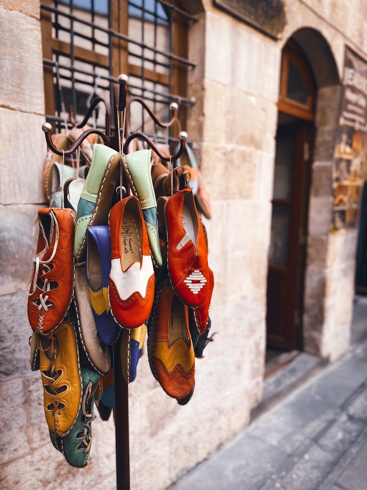 Shoes Hanging On A Rack Outside A Building