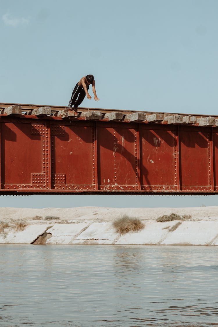 A Man Jumping On The River