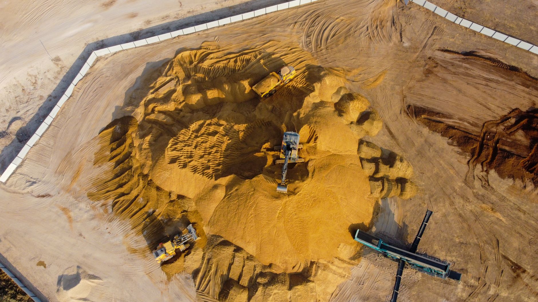 Drone shot capturing industrial sand extraction in Ashdod, South District, Israel.