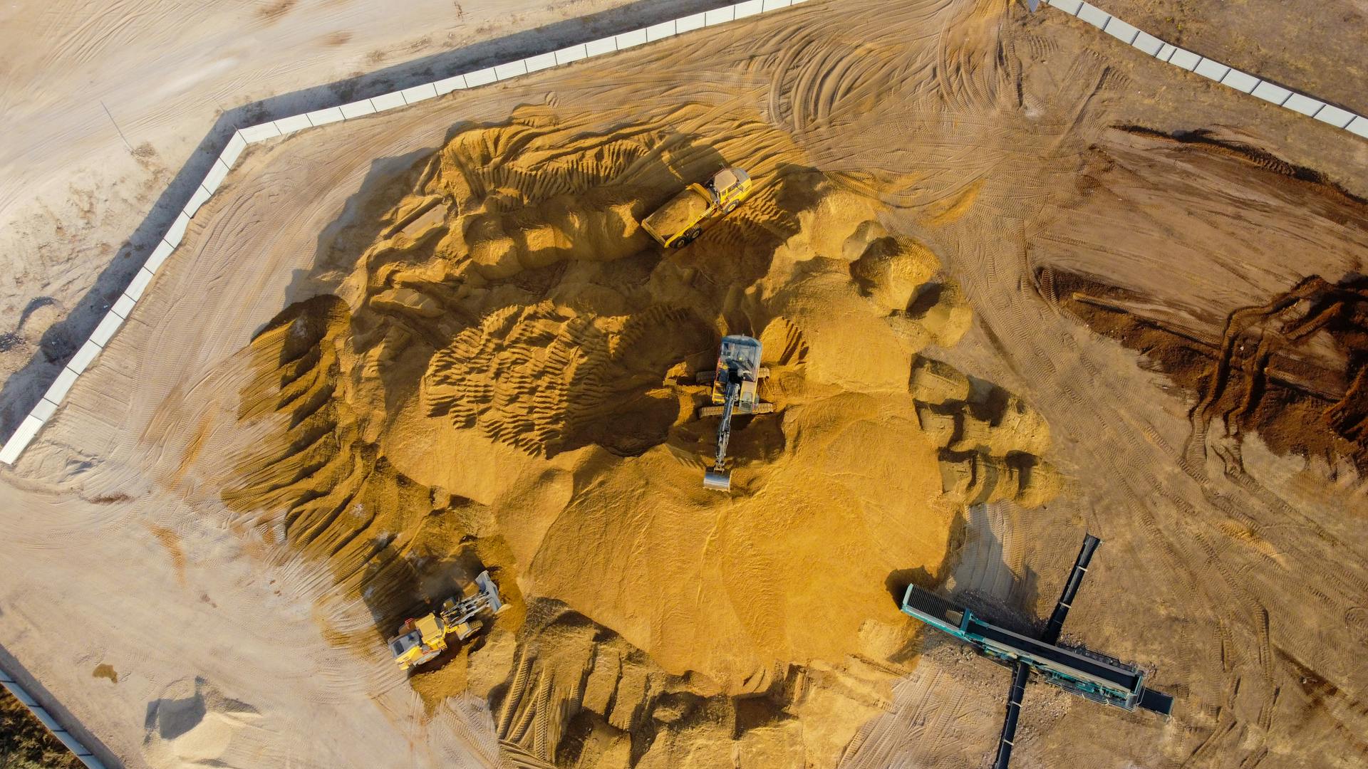 Drone shot capturing industrial sand extraction in Ashdod, South District, Israel.