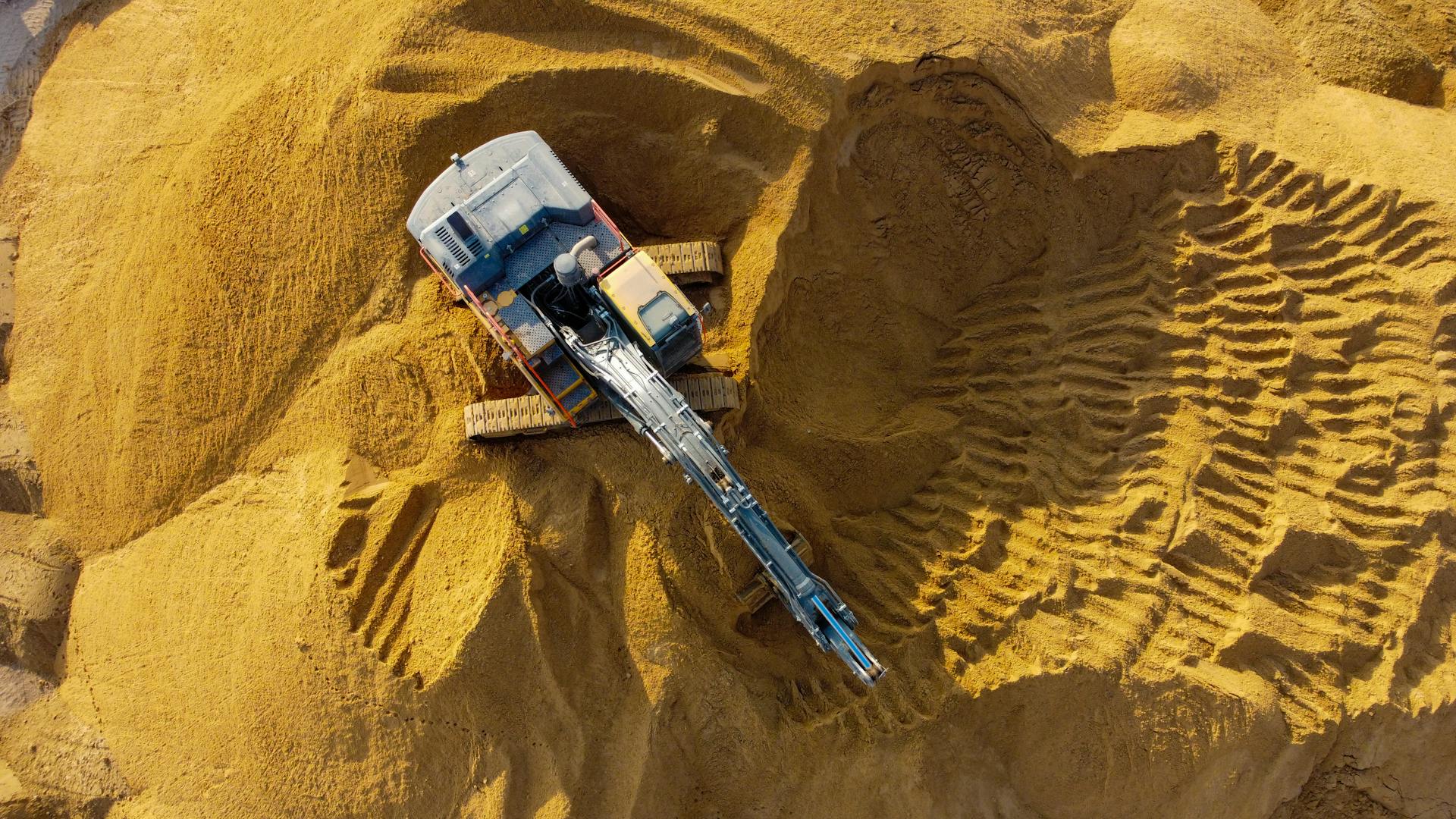 Drone captures an excavator digging sand in Ashdod, highlighting industrial activity.