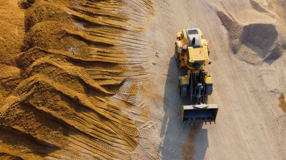 Aerial shot of loader operating on sandy construction site in Ashdod, Israel.