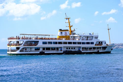 White and Yellow Ferry Boat on Sea