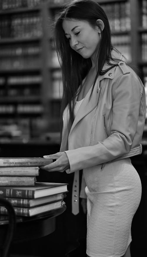 Free Grayscale Photo of a Woman Looking at a Book Stock Photo