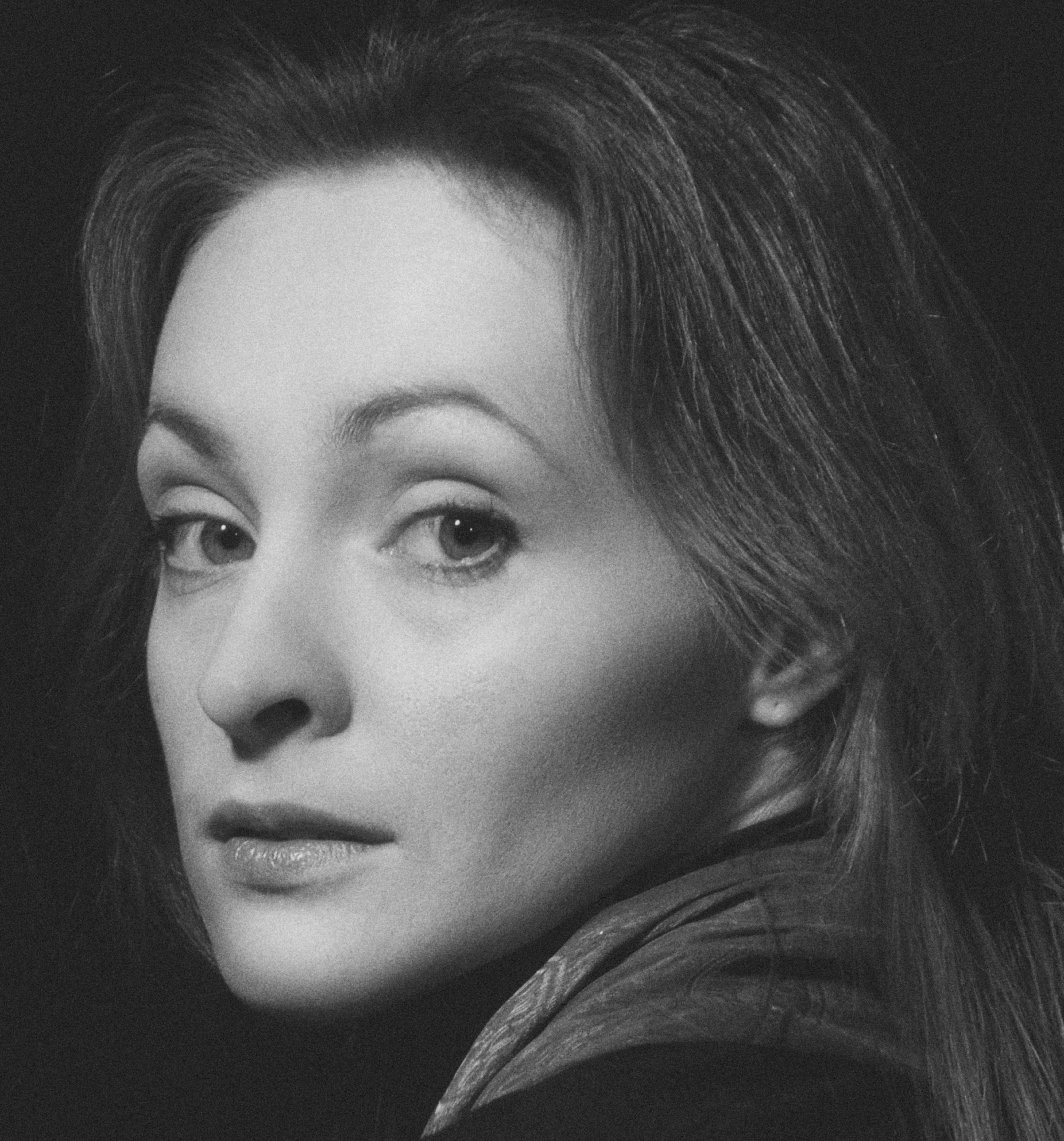 A captivating black and white portrait of a woman with a serene expression in Kyiv, Ukraine.