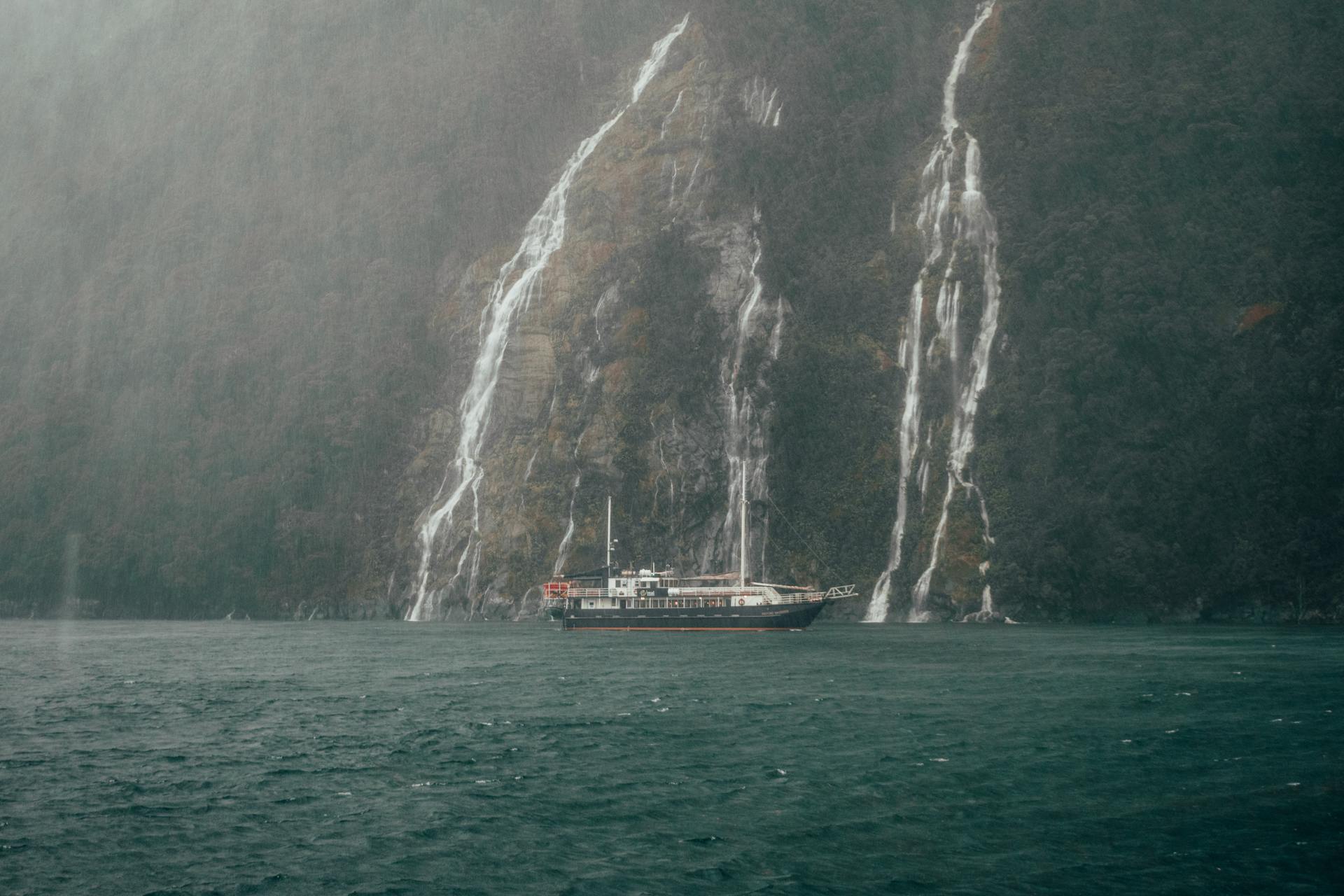 Passenger Ship near Waterfall on Sea Shore
