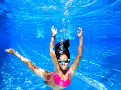 A Woman in Pink Swimsuit in Water