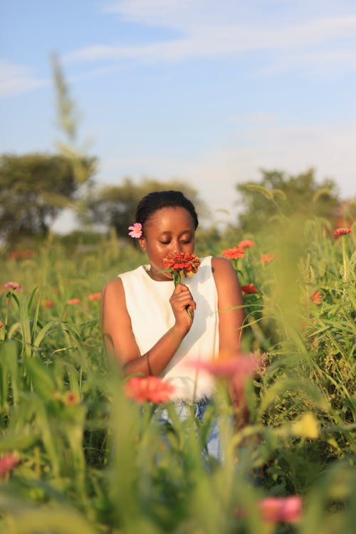 A Woman Smelling a Flower