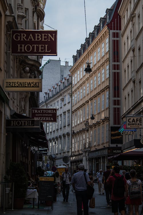 People Walking on City Street near Buildings