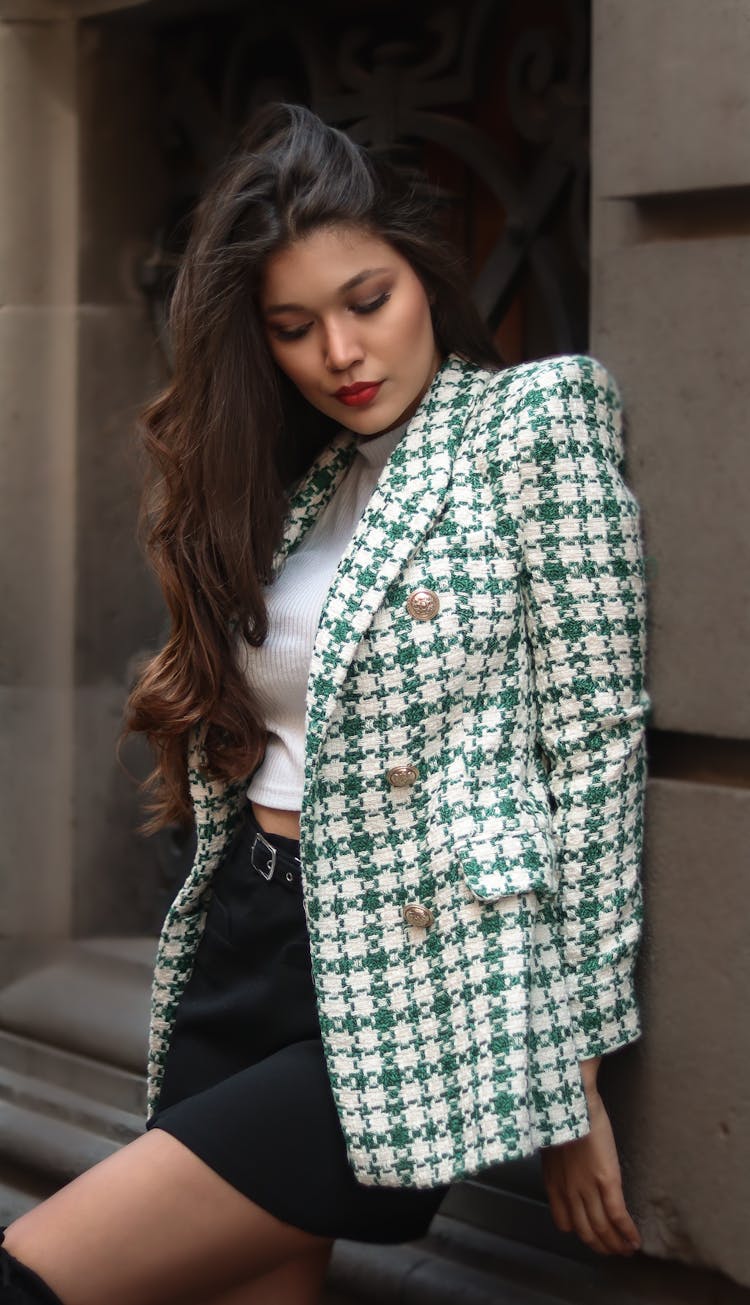 Standing Beautiful Woman Wearing A Checked Jacket, A Black Skirt And A White Shirt